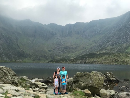 family in front of lake small